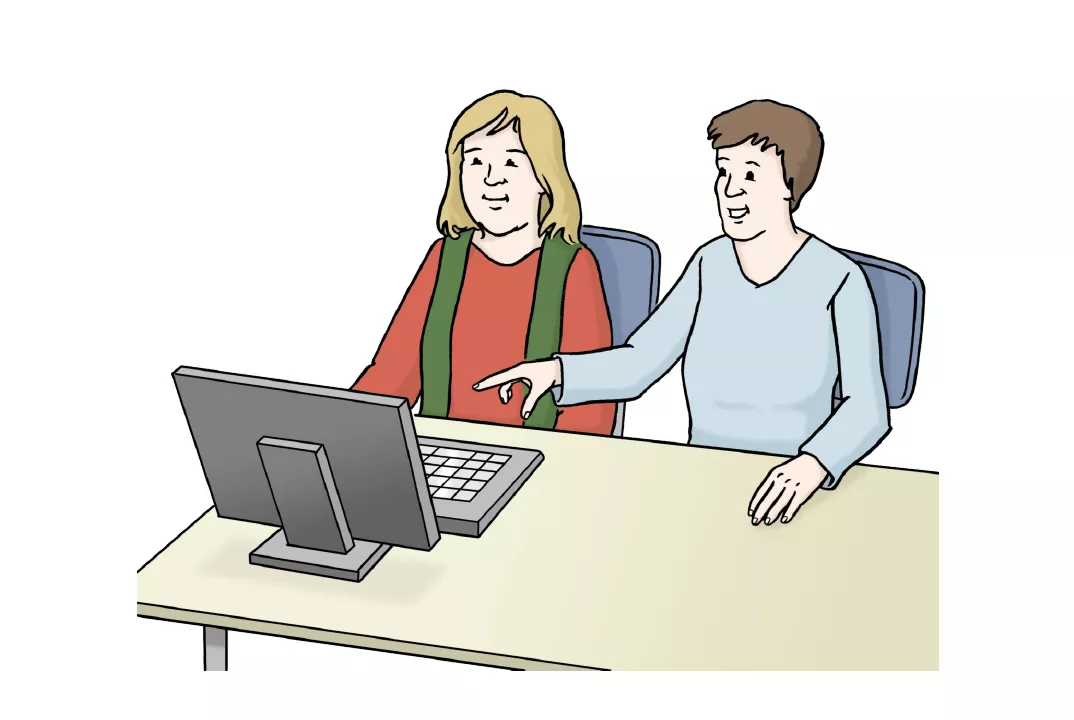 Leichte Sprache Zwei Frauen sitzen vor einem Computer und schauen auf den Bildschirm.